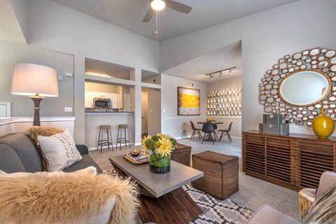 a living room with a couch and a tableat Creekside at Legacy, Texas